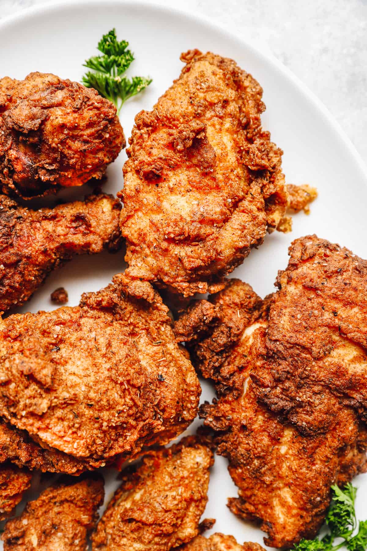 kentucky fried chicken thighs and legs on a white plate.
