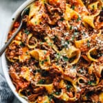 overhead view of slow cooker beef ragu in a white bowl with a fork.