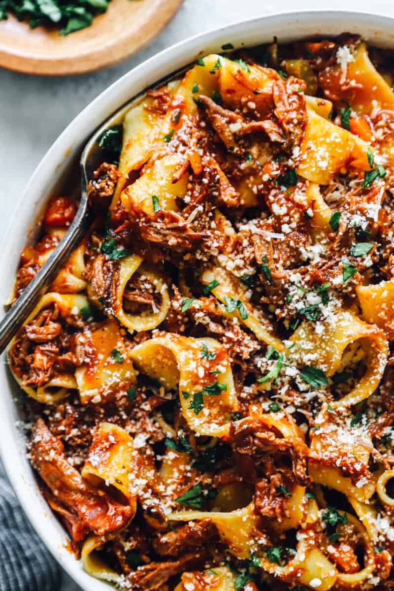 overhead view of slow cooker beef ragu in a white bowl with a fork.