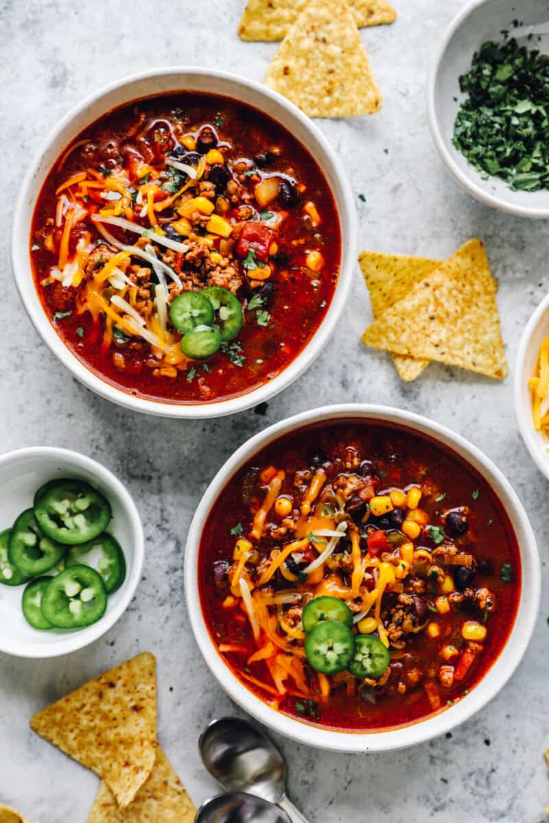 overhead view of crockpot taco soup in white bowls.