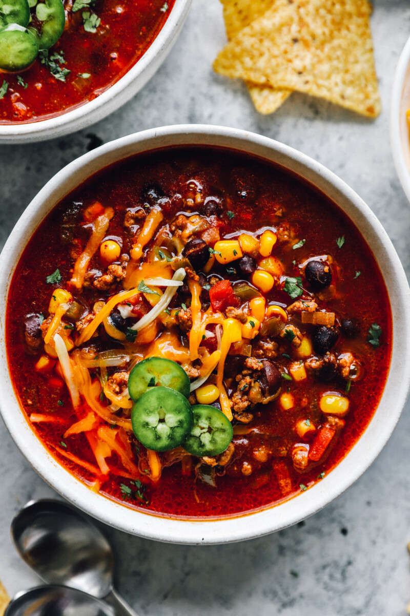 close up of crockpot taco soup in a white bowl.