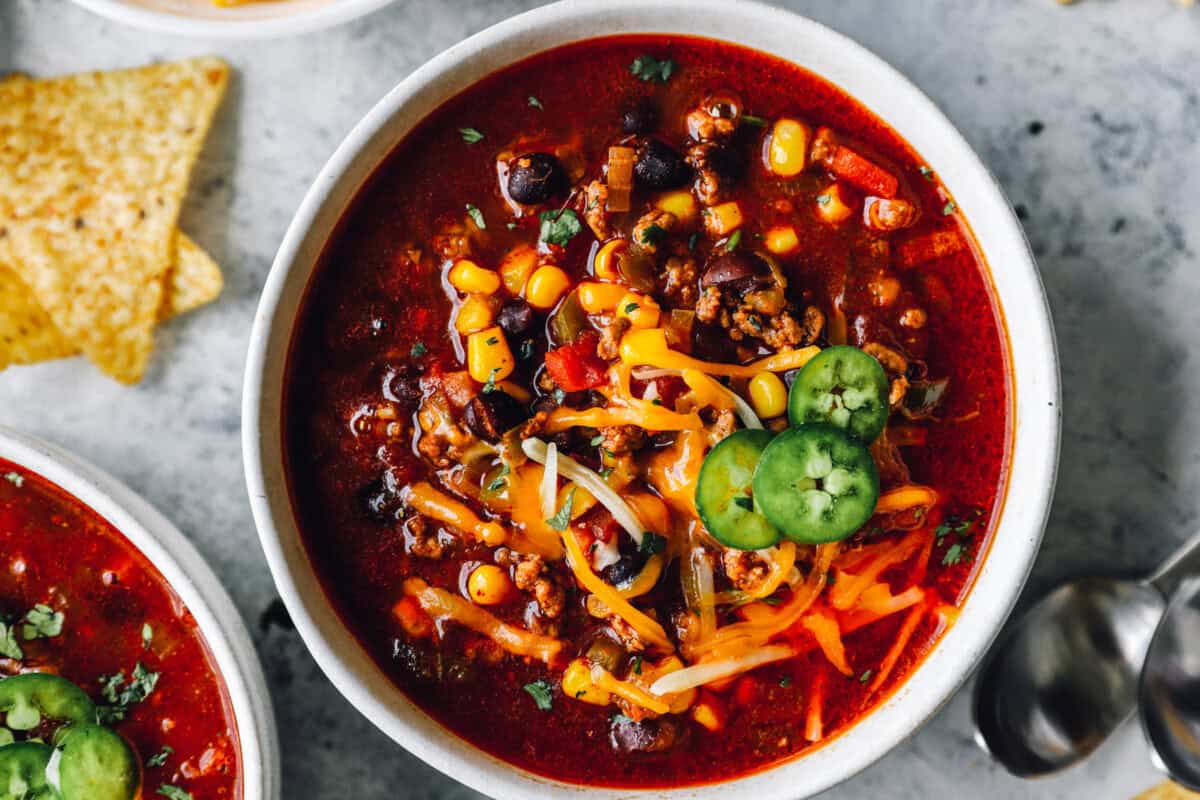 close up of crockpot taco soup in a white bowl.