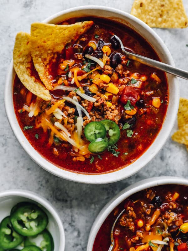 overhead view of crockpot taco soup in a white bowl with a spoon.