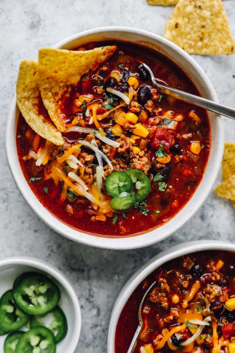 overhead view of crockpot taco soup in a white bowl with a spoon.