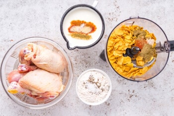 overhead view of ingredients for air fryer fried chicken in glass bowls.