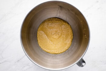 overhead view of wet ingredients for chocolate pound cake in a stainless mixing bowl.