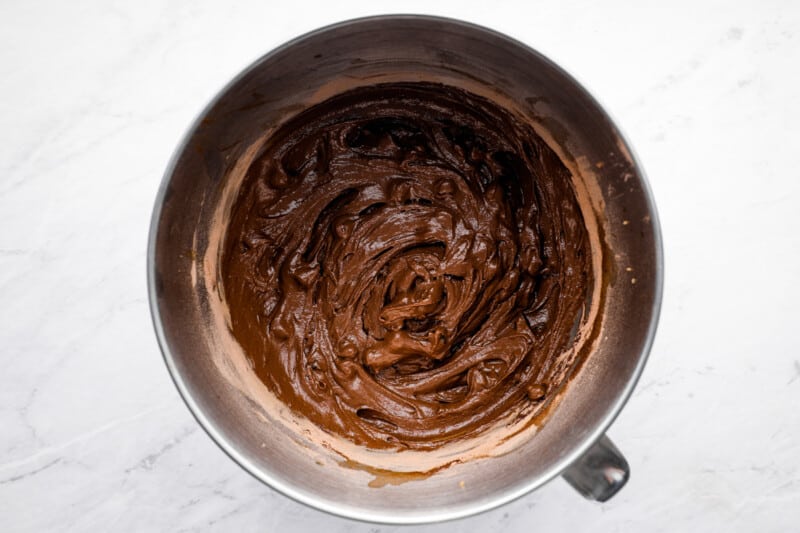 overhead view of chocolate pound cake batter in a stainless mixing bowl.