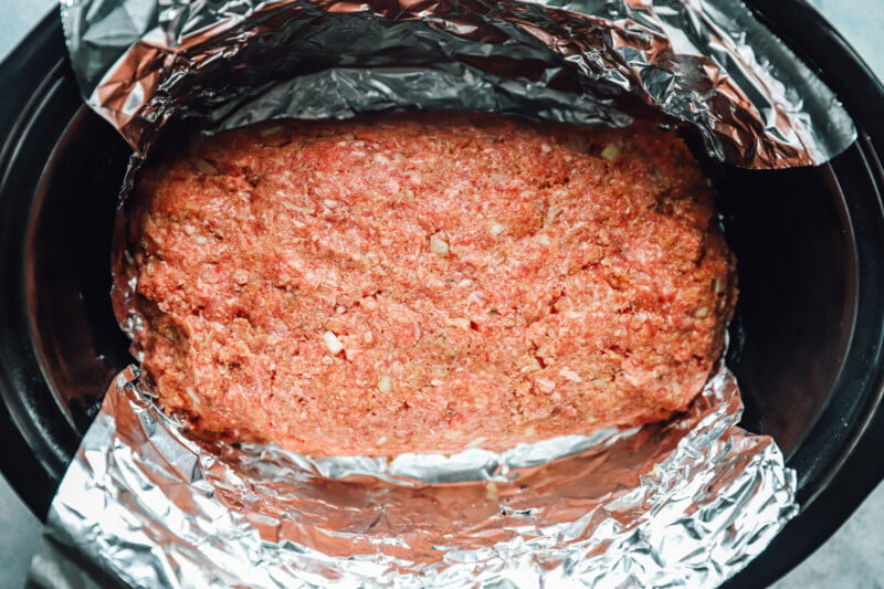 overhead view of uncooked crockpot meatloaf in a crockpot.