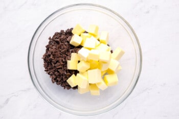 overhead view of cubed butter and chocolate in a glass bowl.
