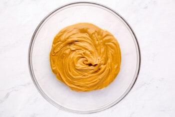 overhead view of peanut butter swirl in a glass bowl.