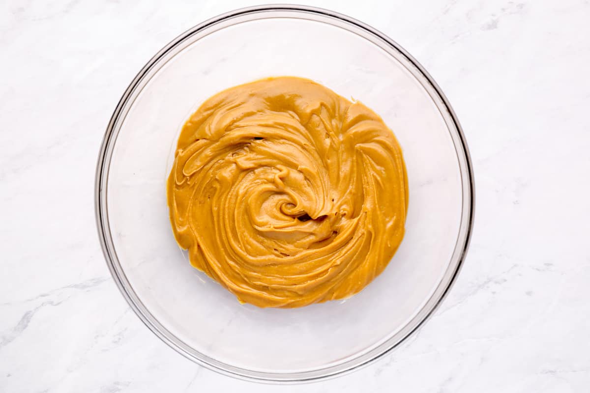 Overhead view of peanut butter swirl in a glass bowl.