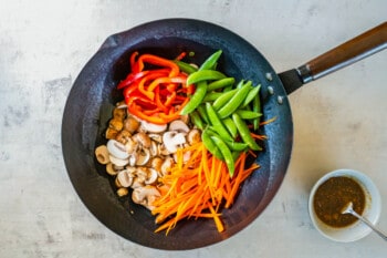 vegetables added to a wok.