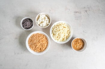 overhead view of ingredients for avalanche cookies in white bowls.
