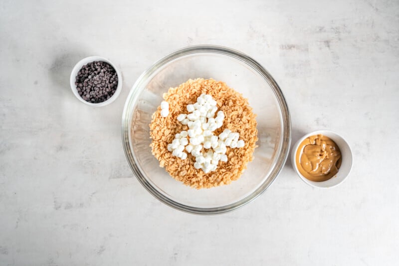 overhead view of rice krispies cereal and marshmallows in a glass bowl.