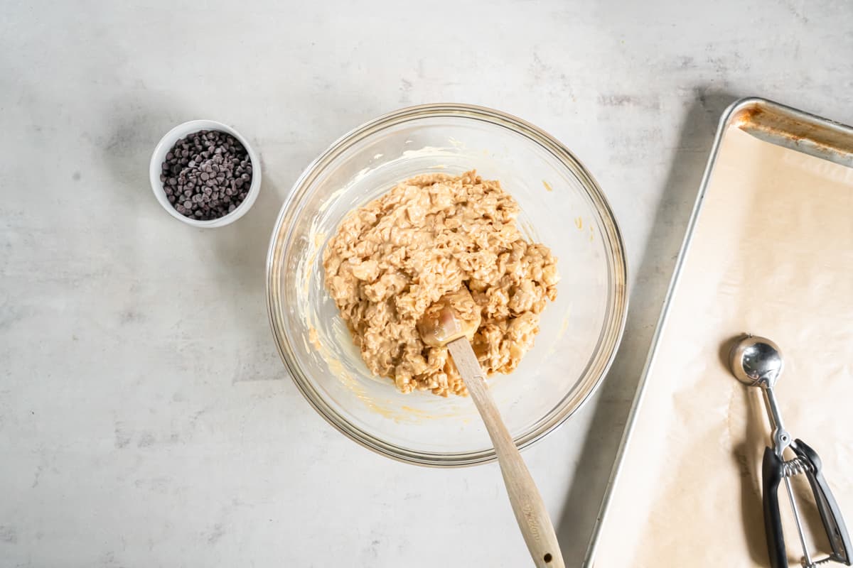 Overhead view of avalanche cookie dough in a glass bowl with a spoon.