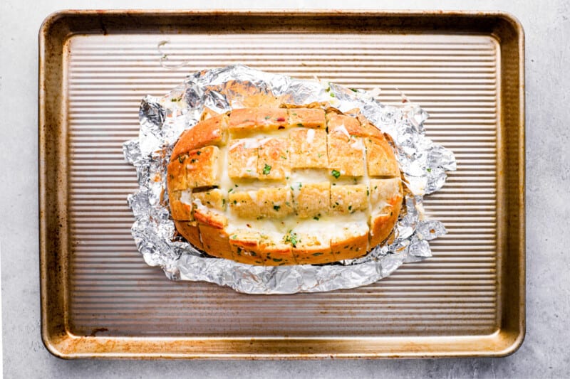 unwrapped pull apart cheese bread on a baking sheet.