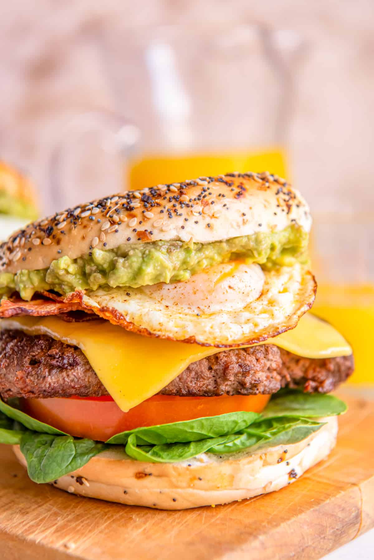 a breakfast burger on a wooden cutting board.