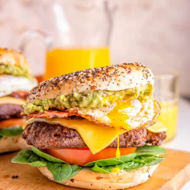 breakfast burgers on a wooden cutting board.