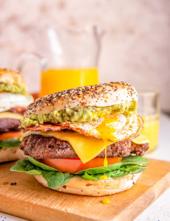 breakfast burgers on a wooden cutting board.