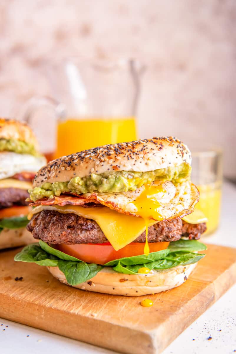 breakfast burgers on a wooden cutting board.