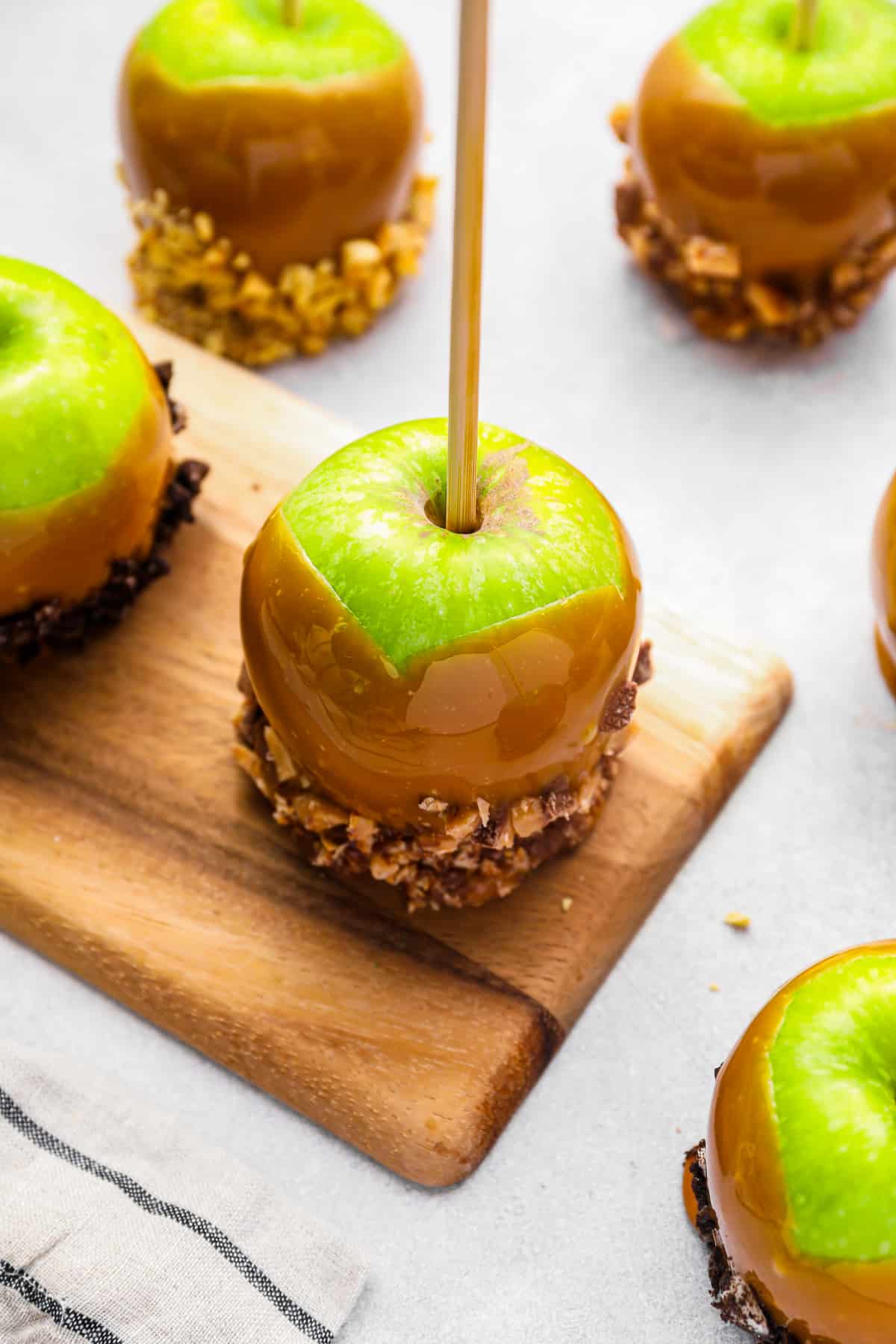 apples coated in caramel and dipped in chopped nuts