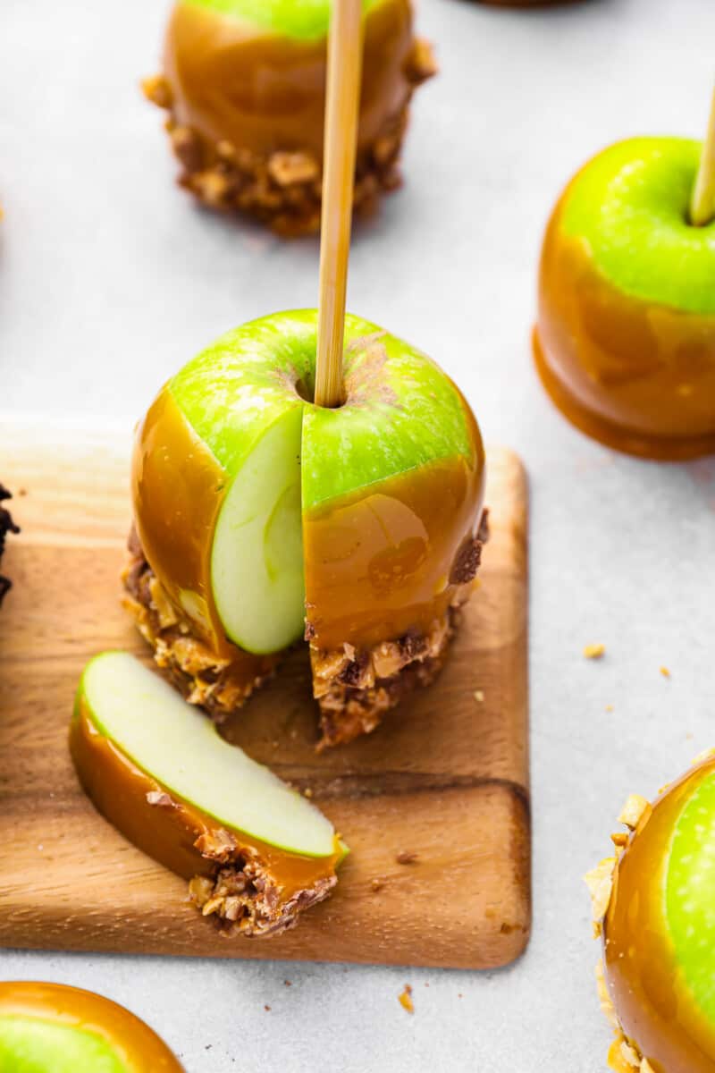 green apple dipped in caramel and nuts