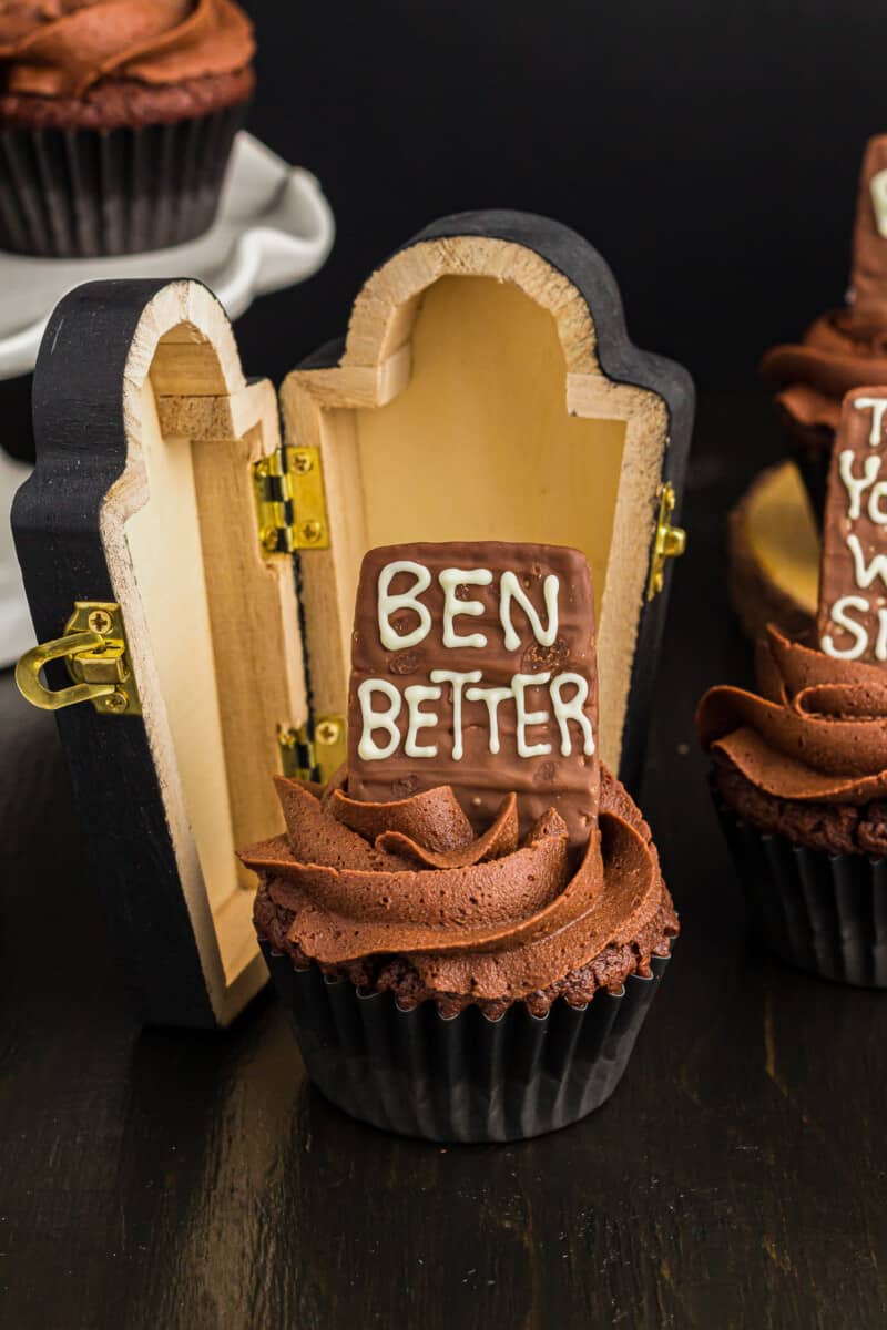 death by chocolate cupcake topped with a graveyard cookie that reads "ben better"