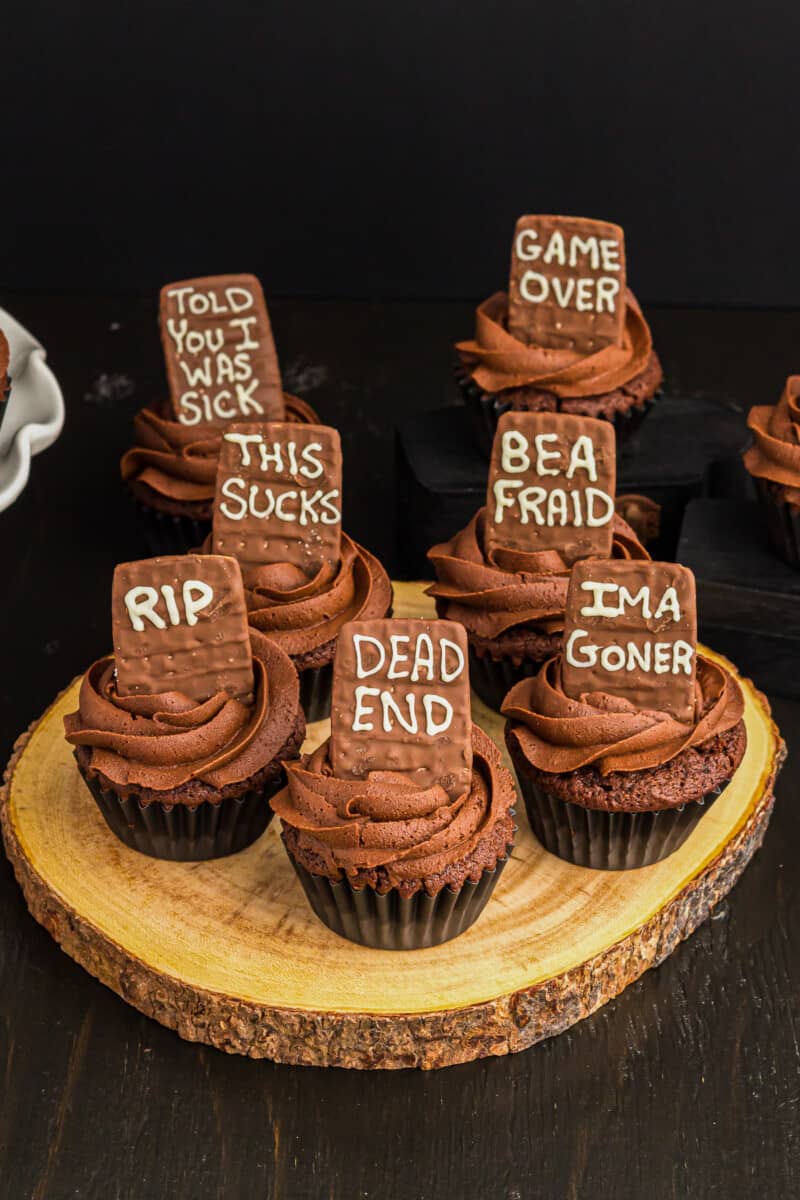death by chocolate cupcakes topped with tombstone cookies with various phrases on them
