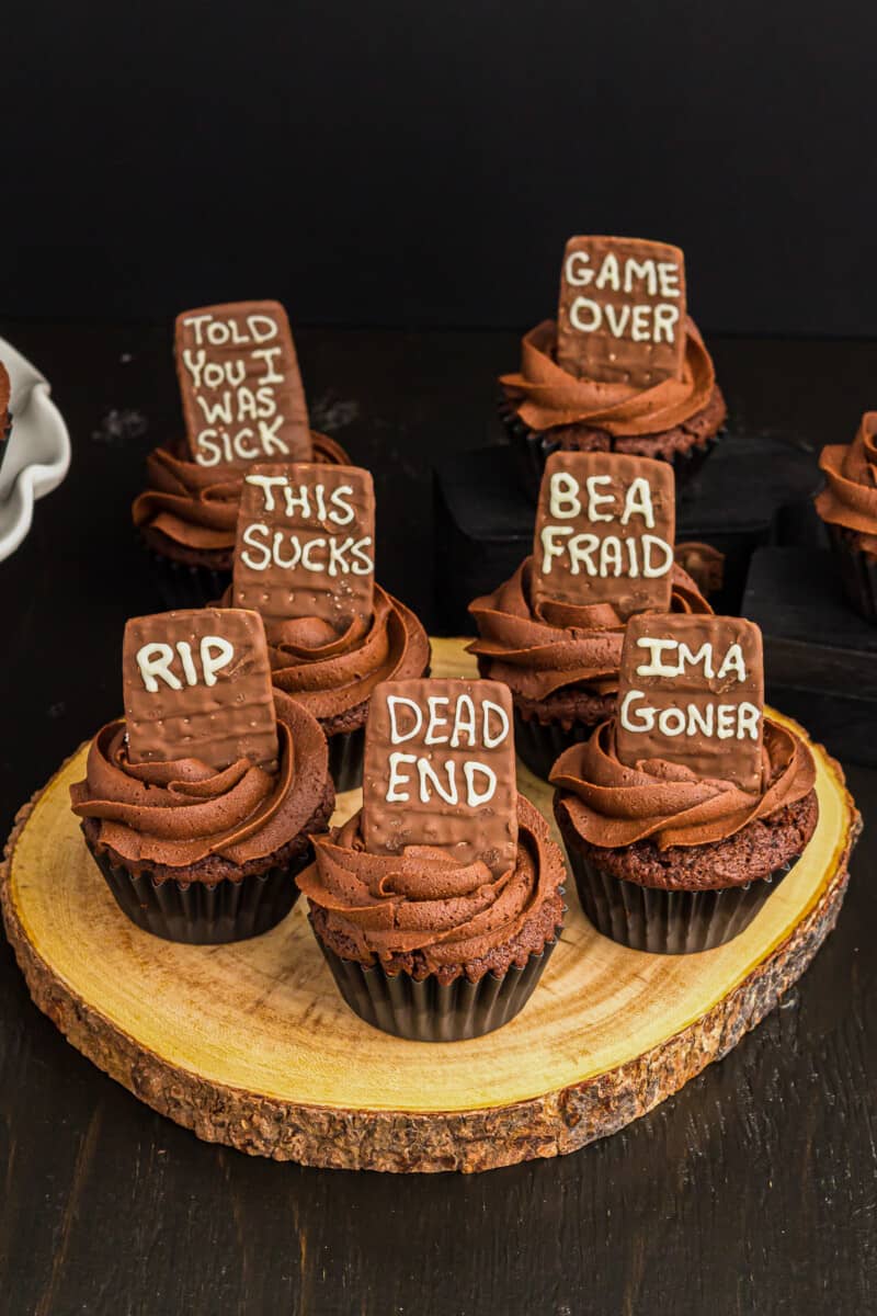 death by chocolate Halloween cupcakes topped with tombstone cookies with various phrases on them