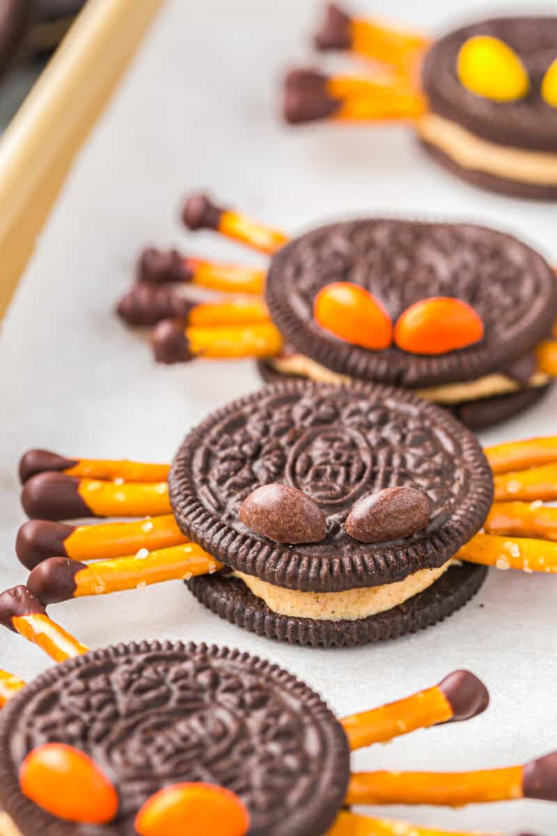 close up on oreo spiders made with pretzel stick legs and Reese's pieces for eyes