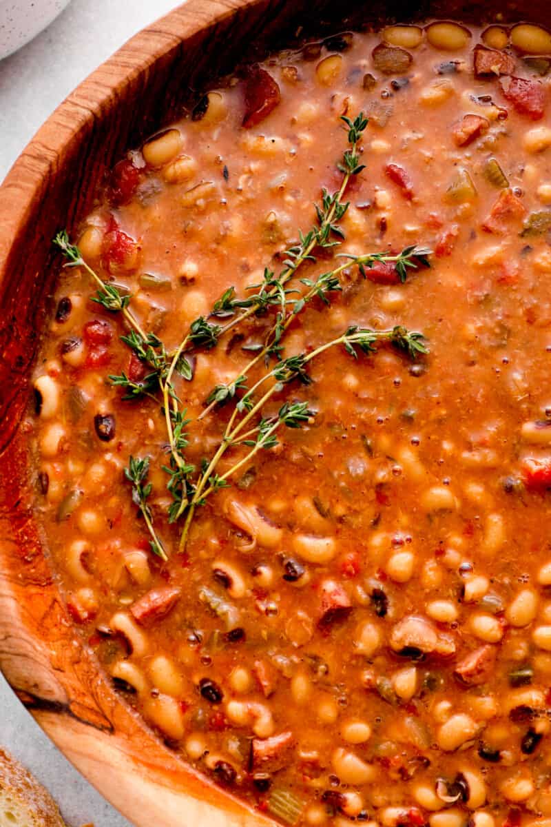 close up view of crockpot black eyed peas in a large serving bowl.