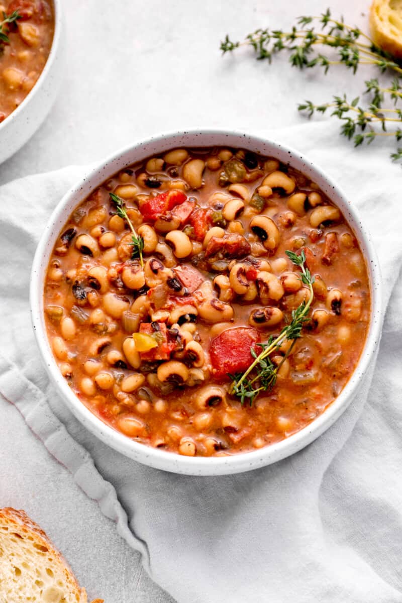 overhead view of crockpot black eyed peas in a white bowl.