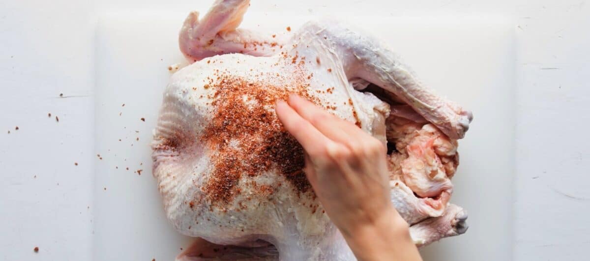 Rubbing the seasoning on the turkey.