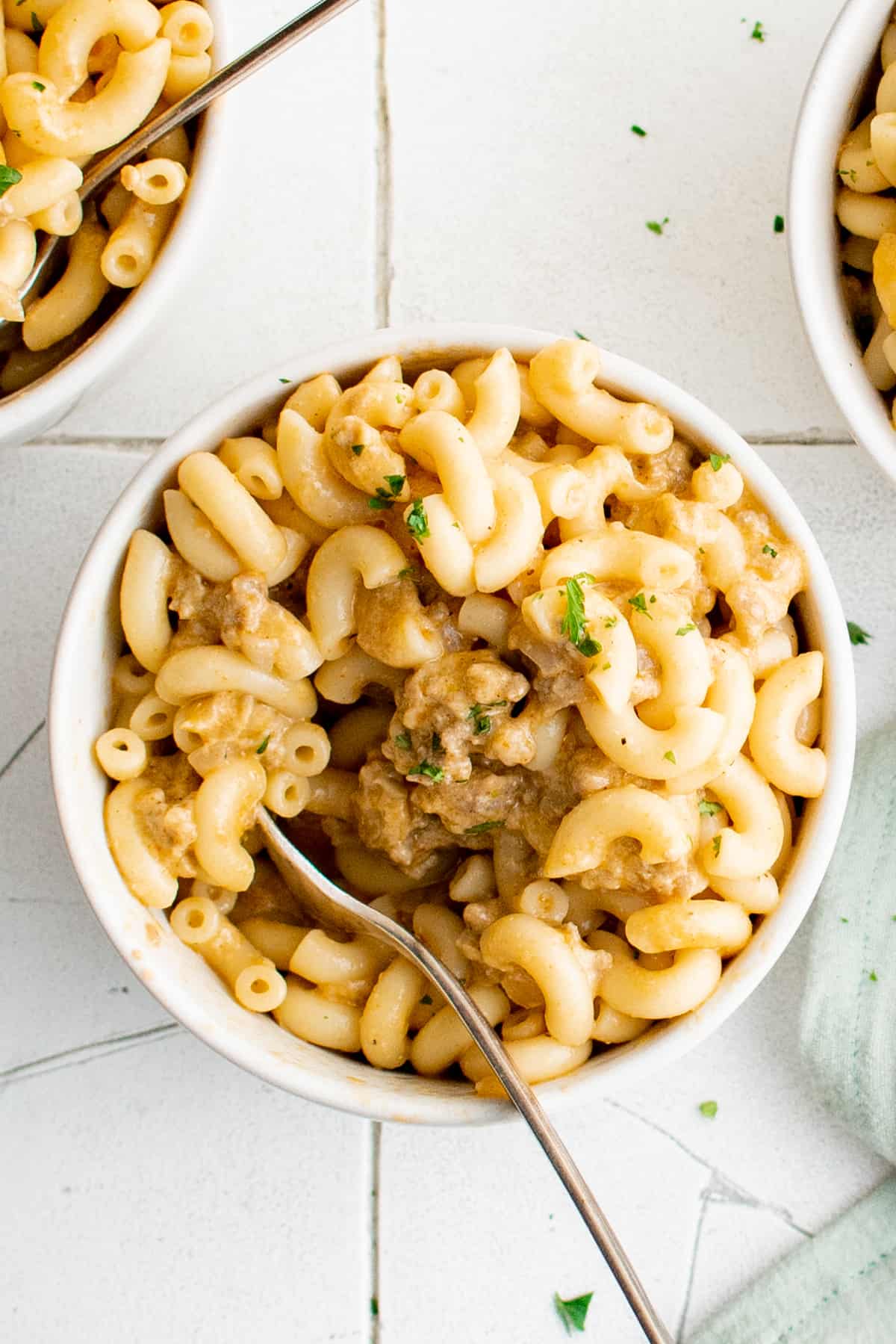 overhead view of hamburger helper in a white bowl with a fork.
