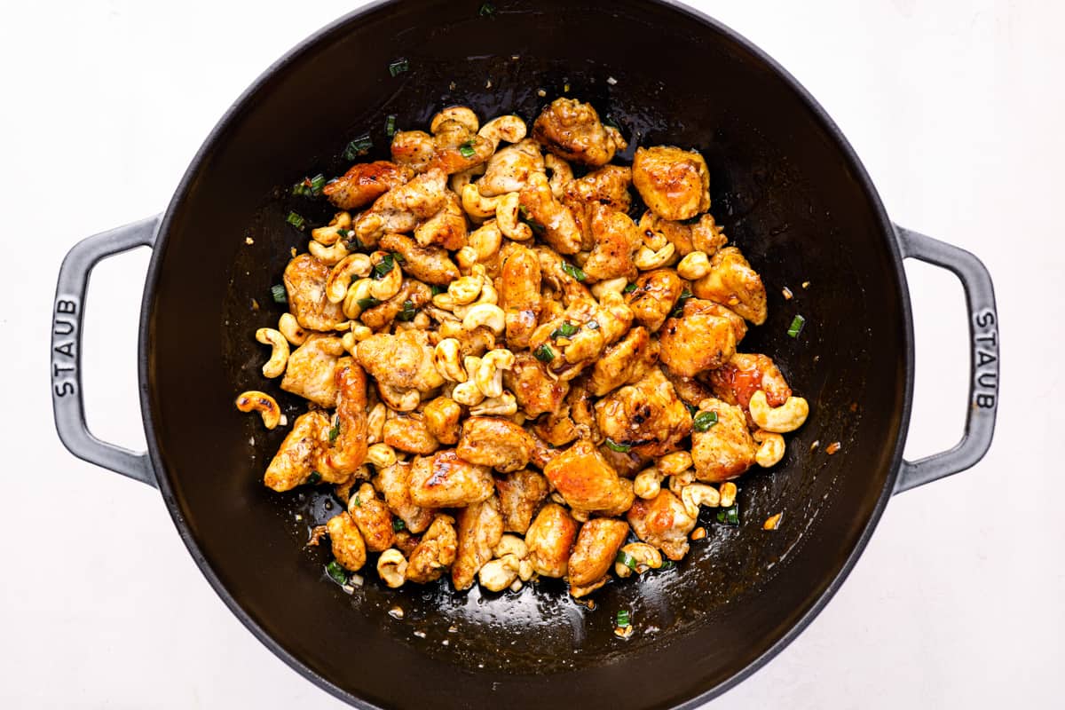 chicken and cashews in a wok.
