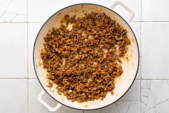 overhead view of cooked seasoned ground beef in a white pan.