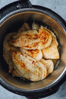 chicken breasts stacked up in an instant pot