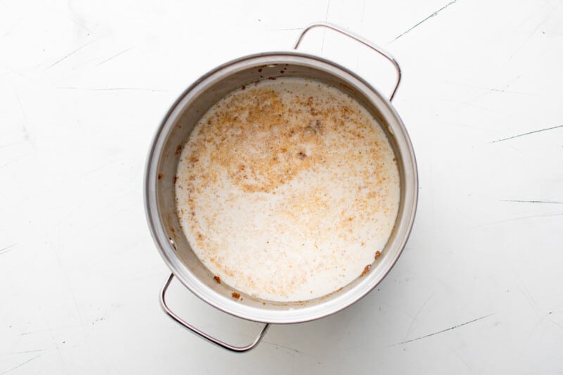 a pot of soup on a white table.