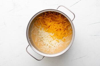 melting shredded cheese in a pot