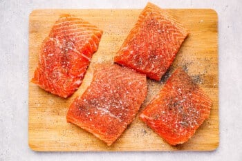 season salmon on a cutting board