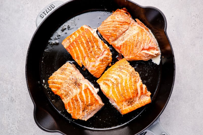 four salmon filets in a skillet