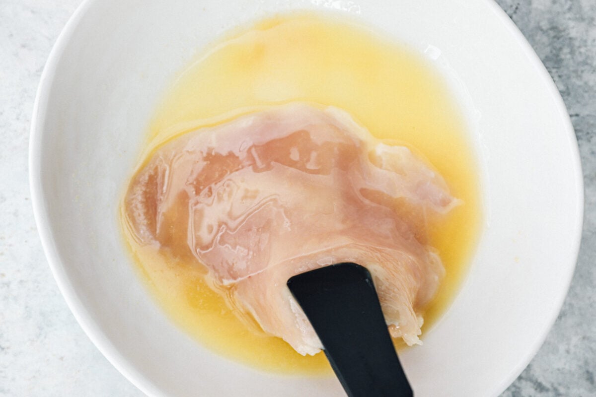 a bowl of chicken in a bowl with a spoon in it.