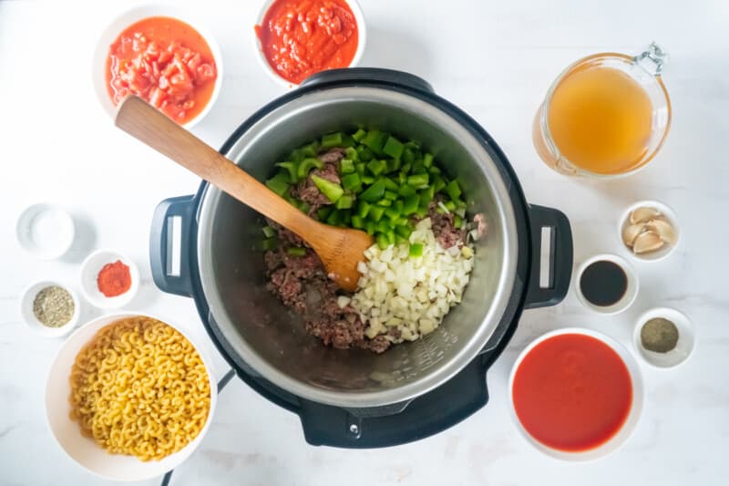 an instant pot filled with pasta, meat, and other ingredients.