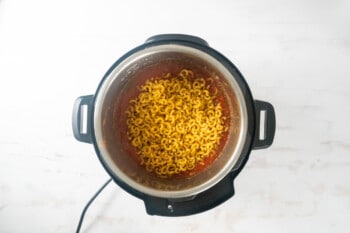 an instant pot filled with noodles.
