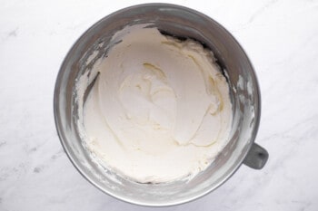 whipped cream in a metal mixing bowl.
