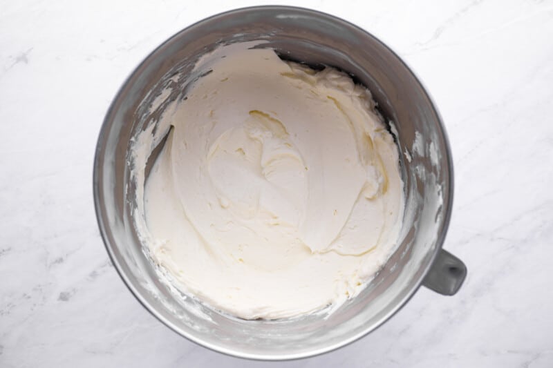 whipped cream in a metal mixing bowl.