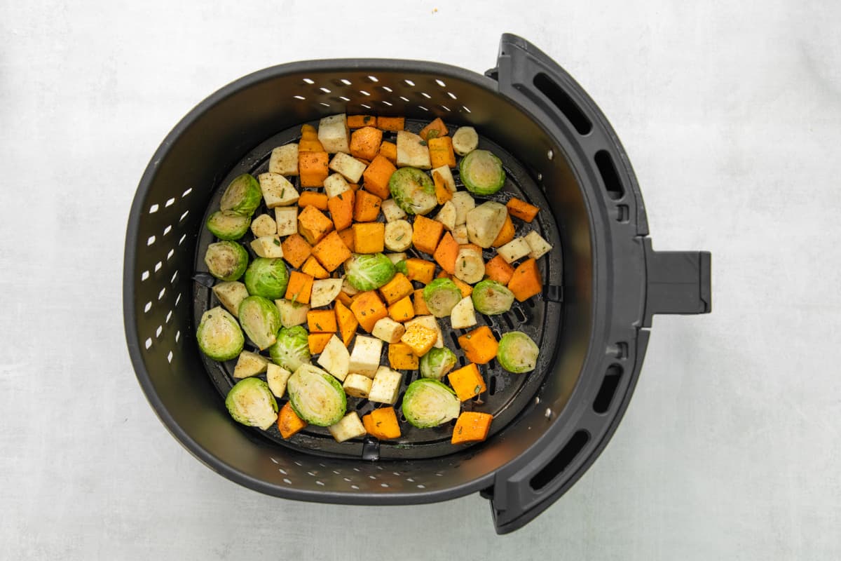 chopped veggies in the basket of an air fryer