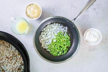onion and celery in a frying pan.
