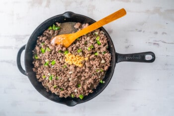 stirring beef with other ingredients in a skillet