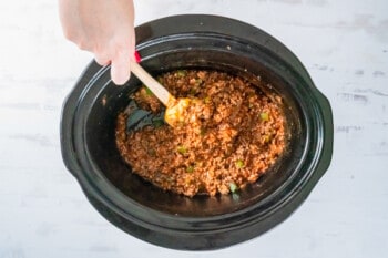 stirring beef with seasonings and ingredients to make sloppy joes